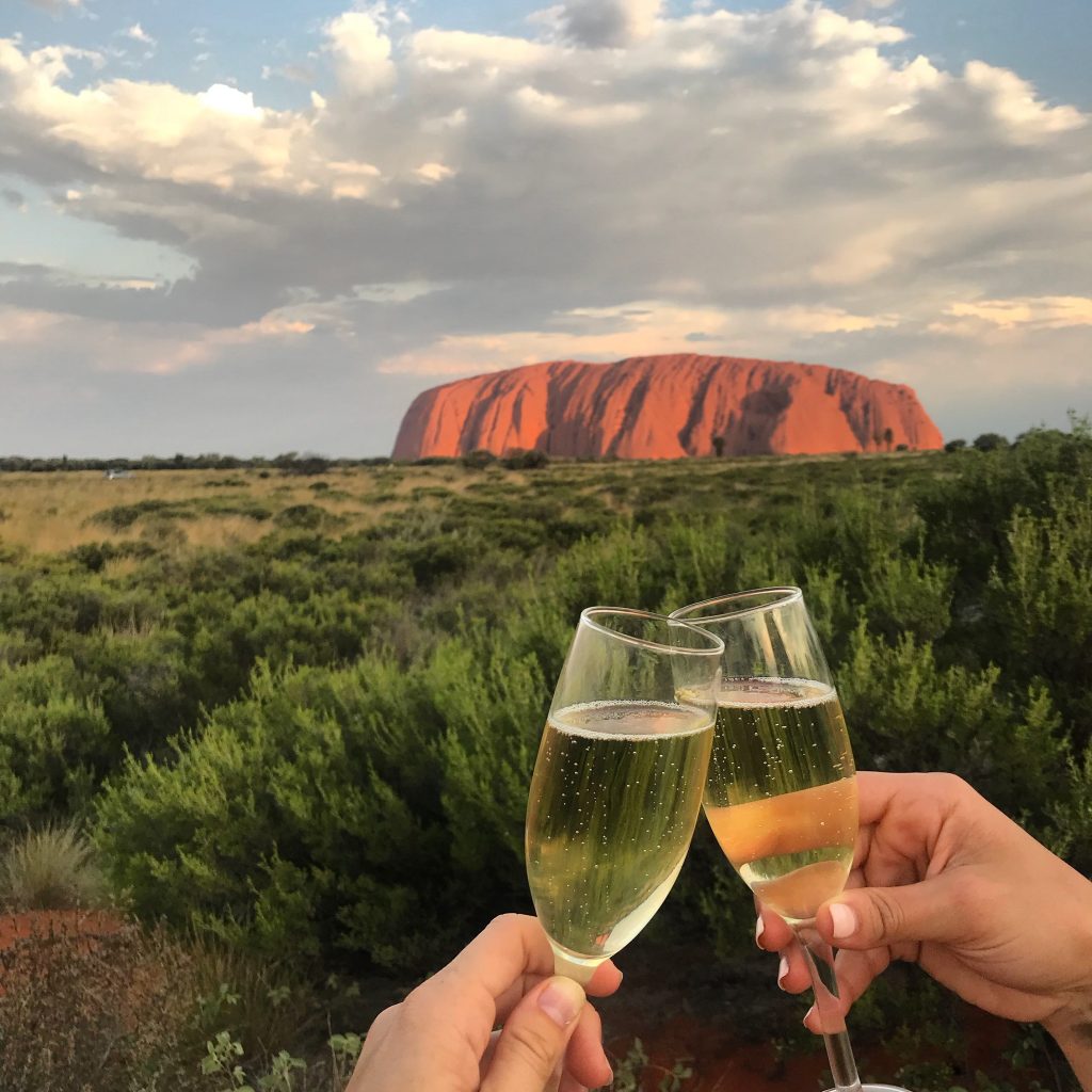 A champagne toast while watching the sunset over Uluru is a highlight of Adventure Tours' Rock to Rock Tour.